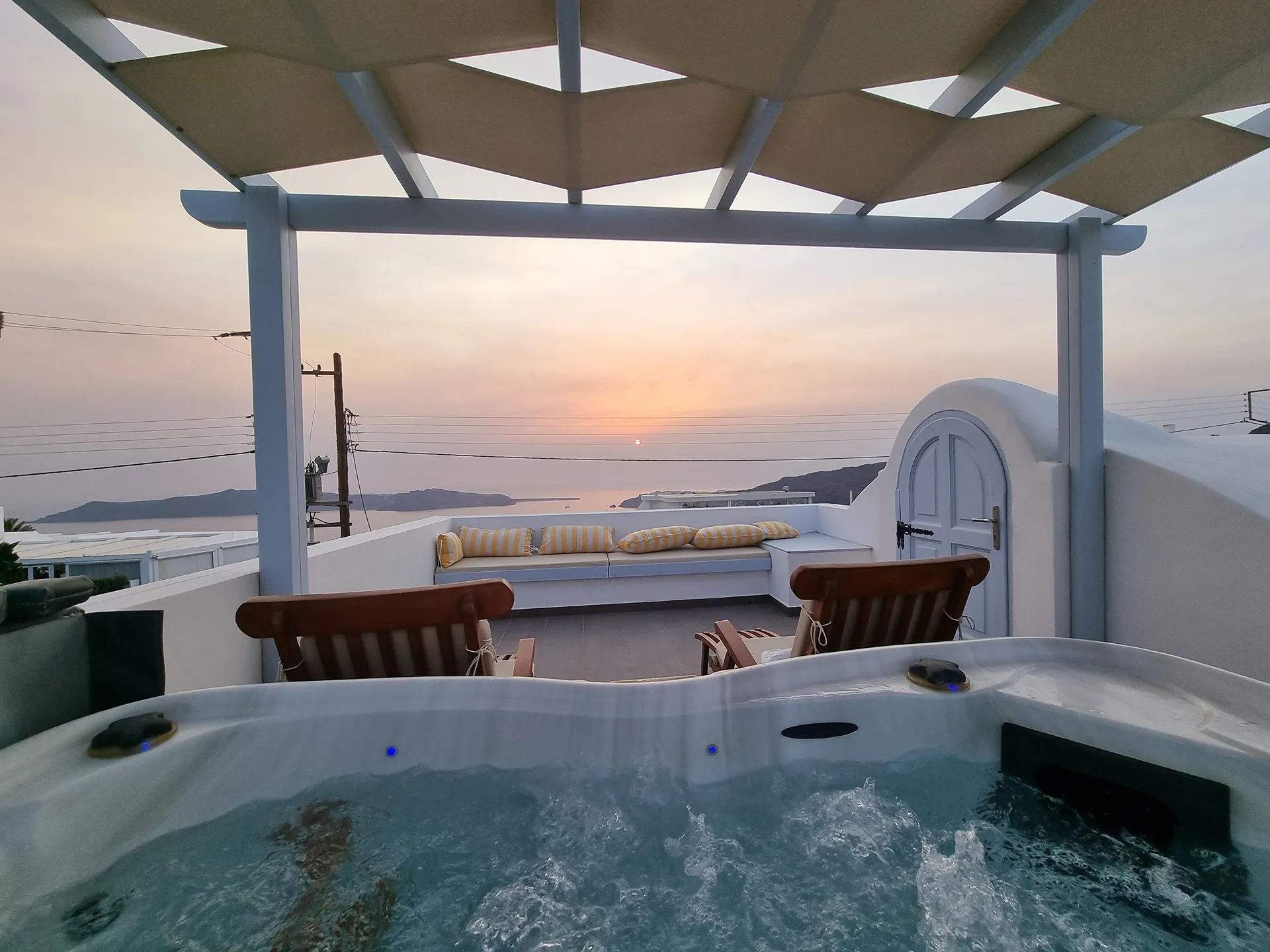 Deluxe apartment terrace with private jacuzzi at sunset